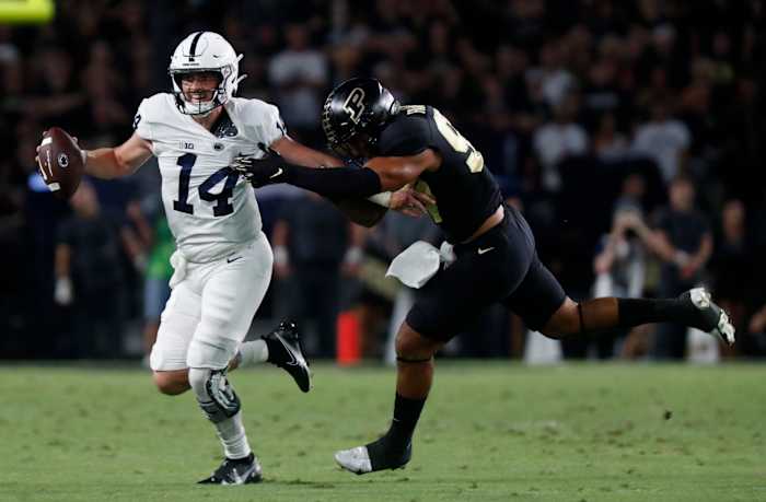 Penn State Nittany Lions quarterback Sean Clifford (14) is rushed by Purdue Boilermakers linebacker Semisi Fakasiieiki (97) during the NCAA football game, Thursday, Sept. 1, 2022, at Ross-Ade Stadium in West Lafayette, Ind. Purduepennstatefb090122 Am00505